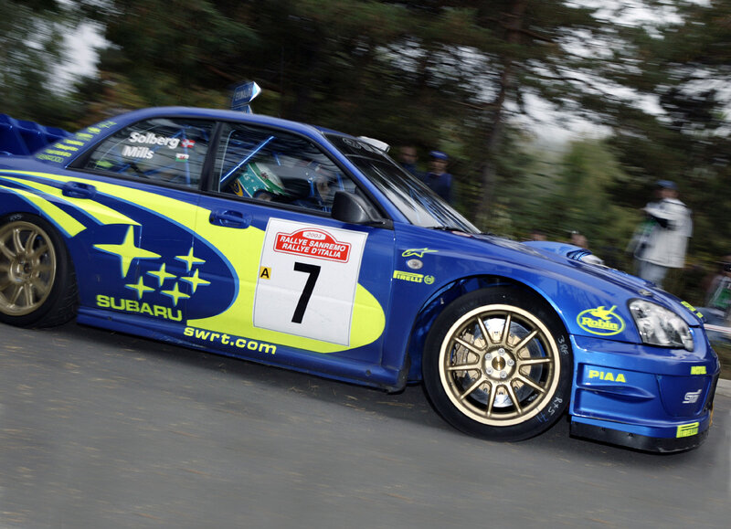 Blue rally car in motion