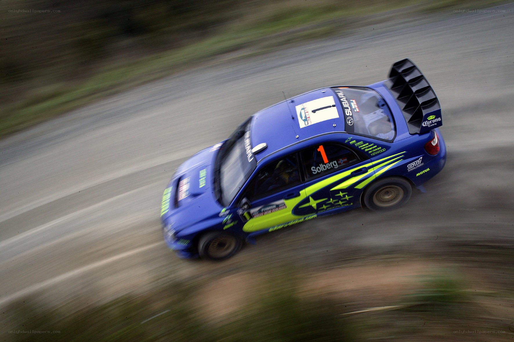 blue rally car in motion