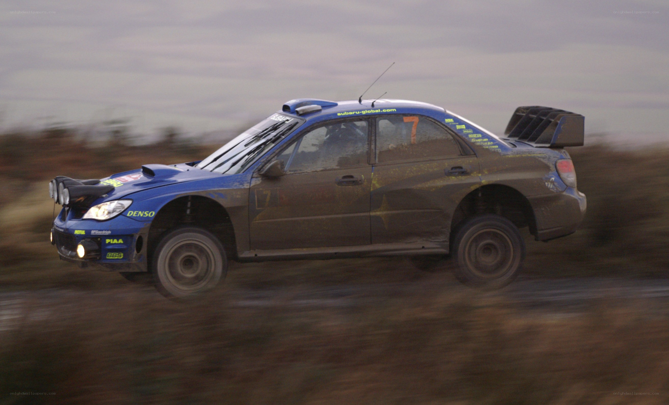 blue rally car in motion