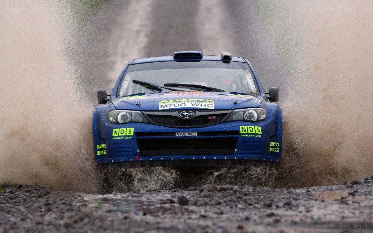 Blue rally car in mud