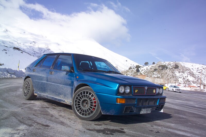 Blue rally car in snowy mountains