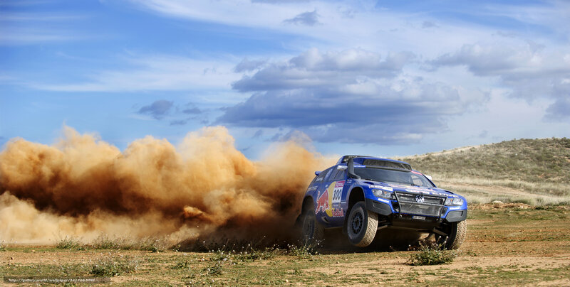 Blue rally car kicking up dust