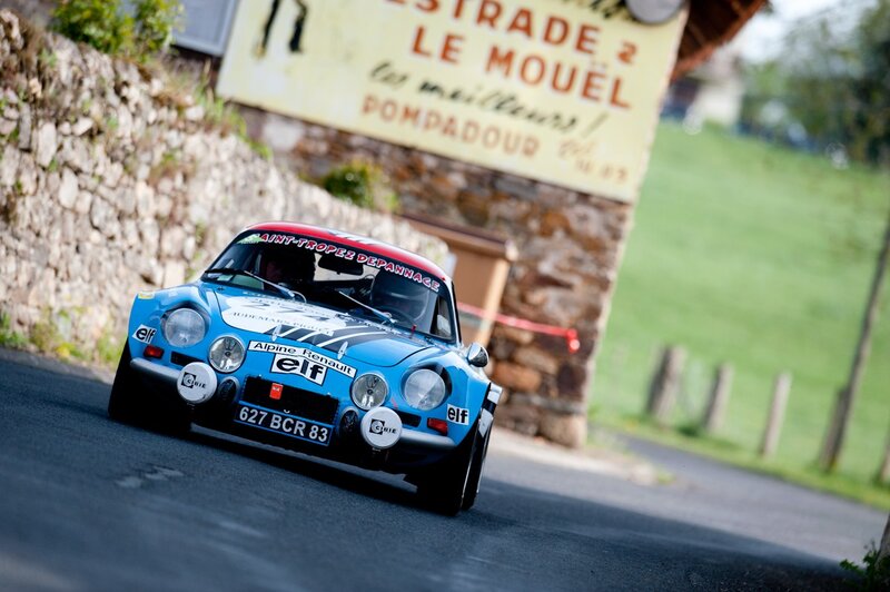 Blue rally car on a winding road