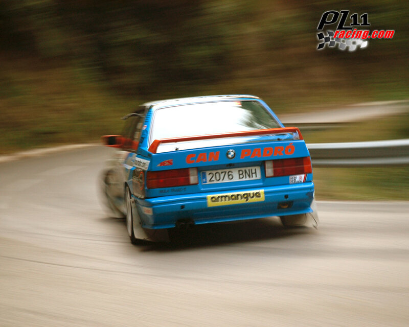 blue rally car on a winding road