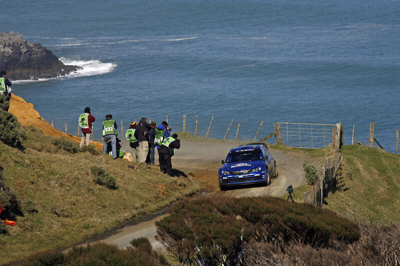 Blue rally car on coastal road