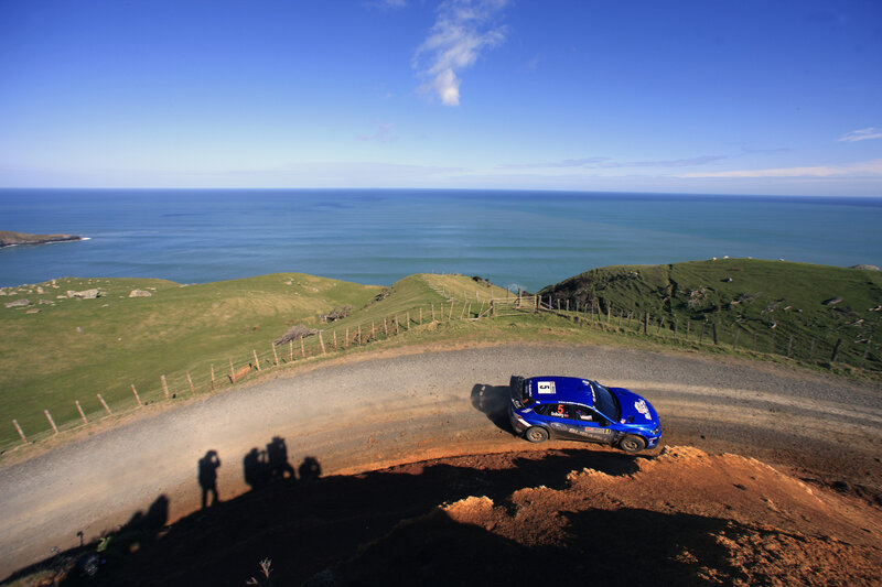Blue rally car on coastal road
