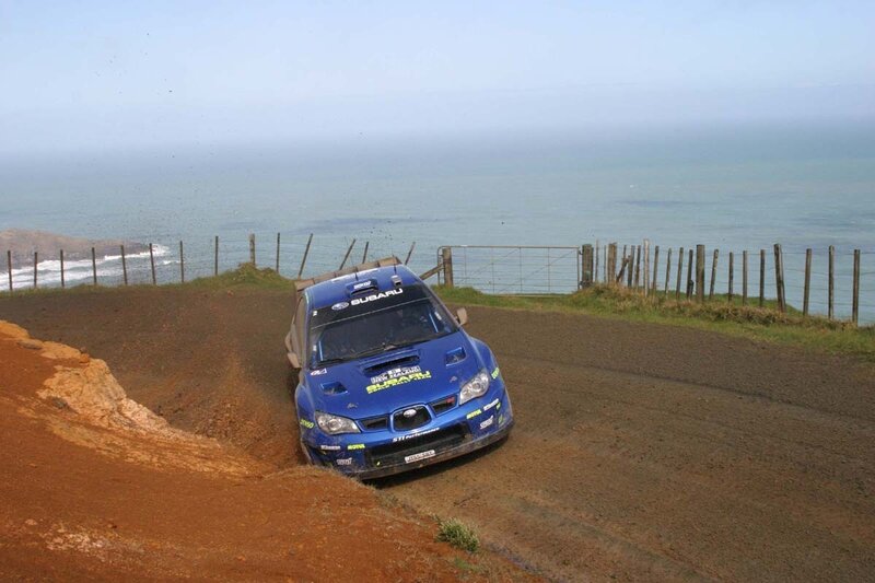 Blue rally car on coastal track