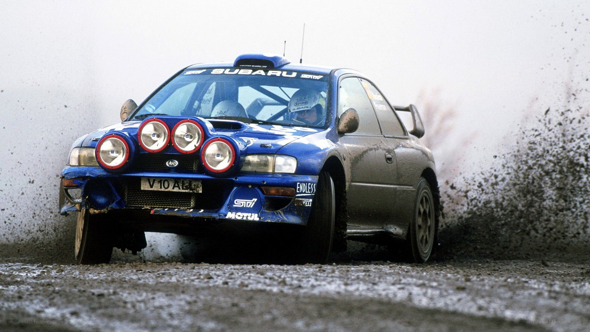 blue rally car on dirt