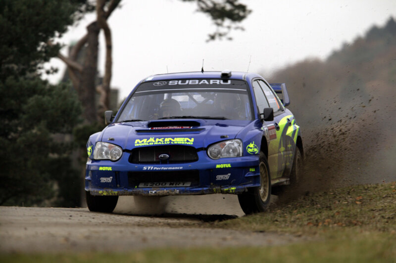 blue rally car on dirt road