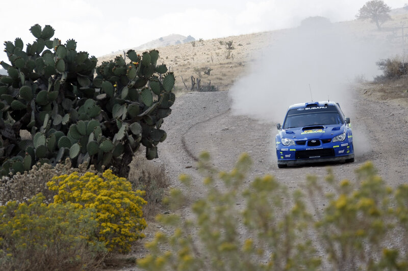 Blue rally car on dirt road