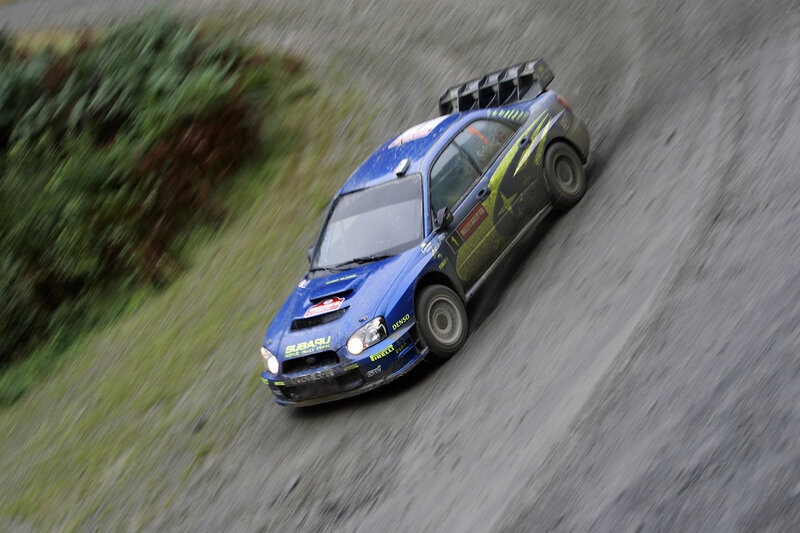 Blue rally car on dirt road