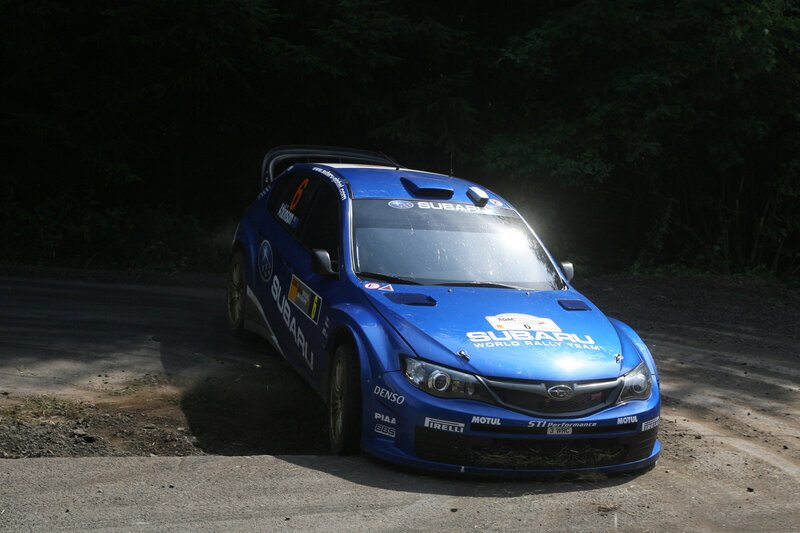 Blue rally car on dirt road