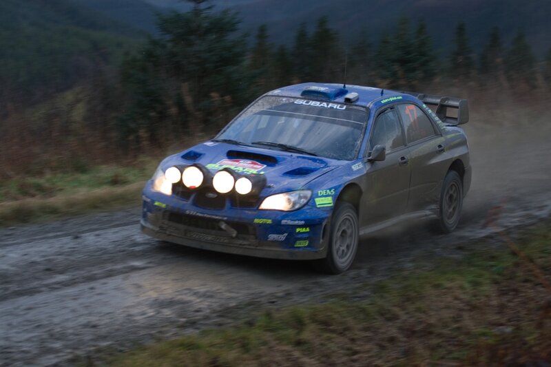 blue rally car on dirt road