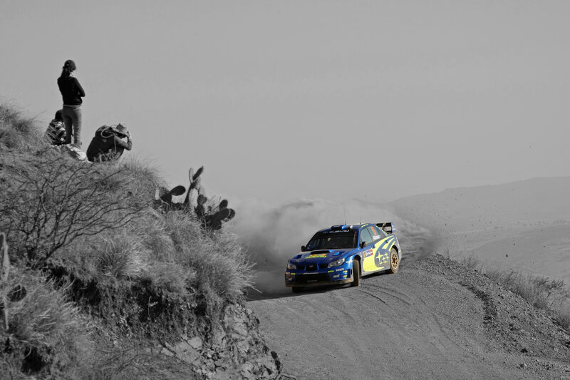 Blue rally car on dirt road