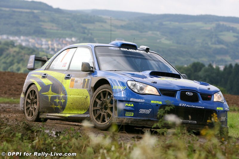 blue rally car on dirt road