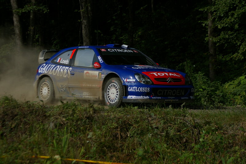 Blue rally car on dirt road