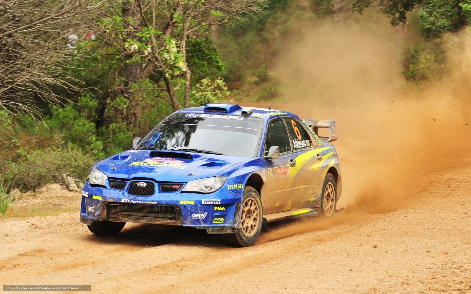 blue rally car on dirt road