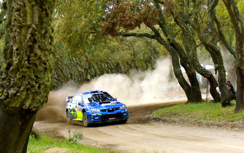 Blue rally car on dirt road