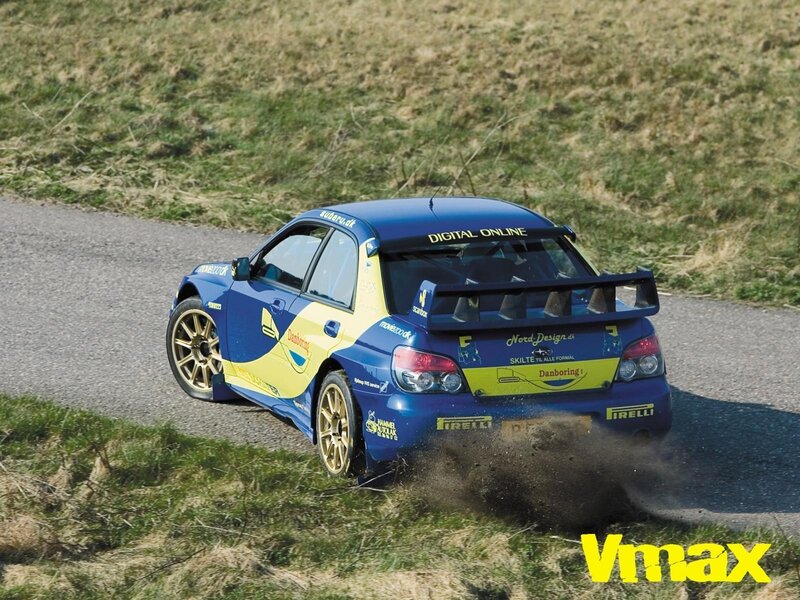 blue rally car on dirt road