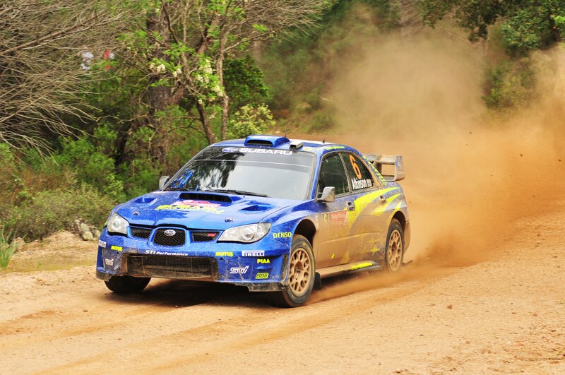 Blue rally car on dirt road