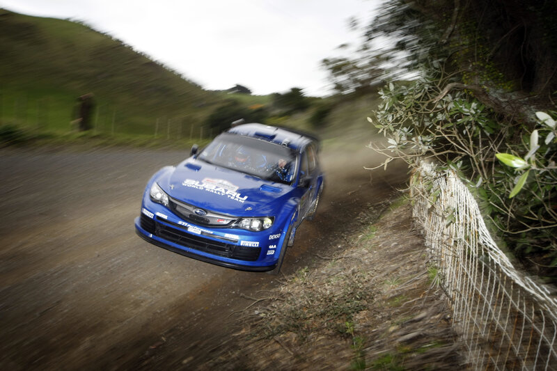 Blue rally car on dirt road