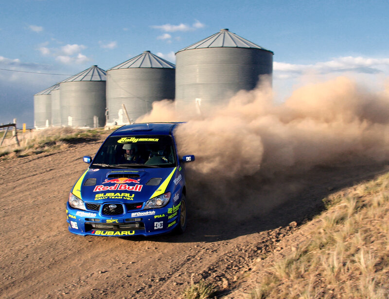 Blue rally car on dirt road
