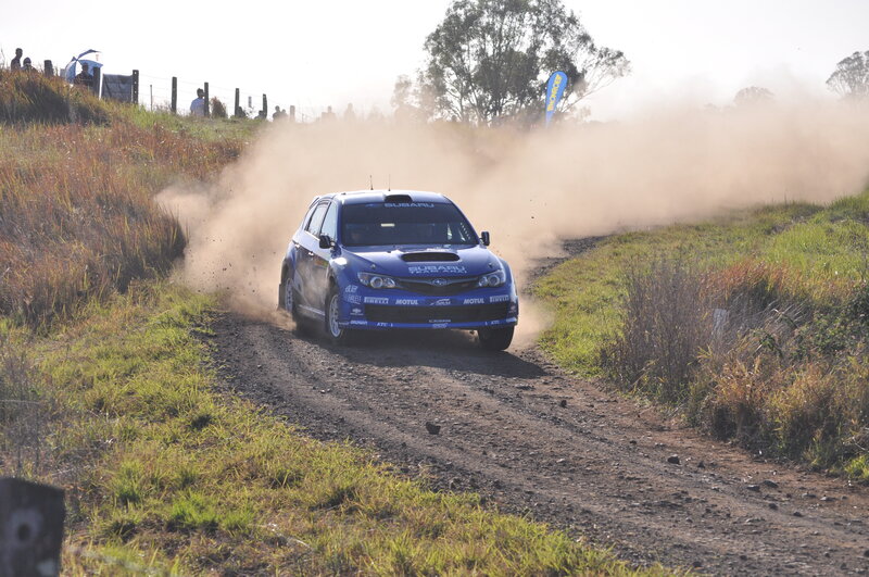 Blue rally car on dirt road