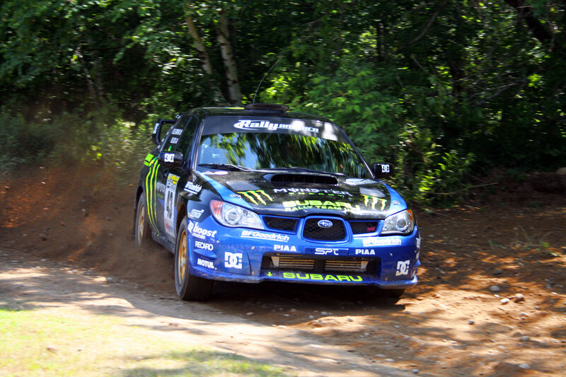 Blue rally car on dirt road