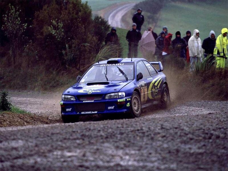 blue rally car on dirt road