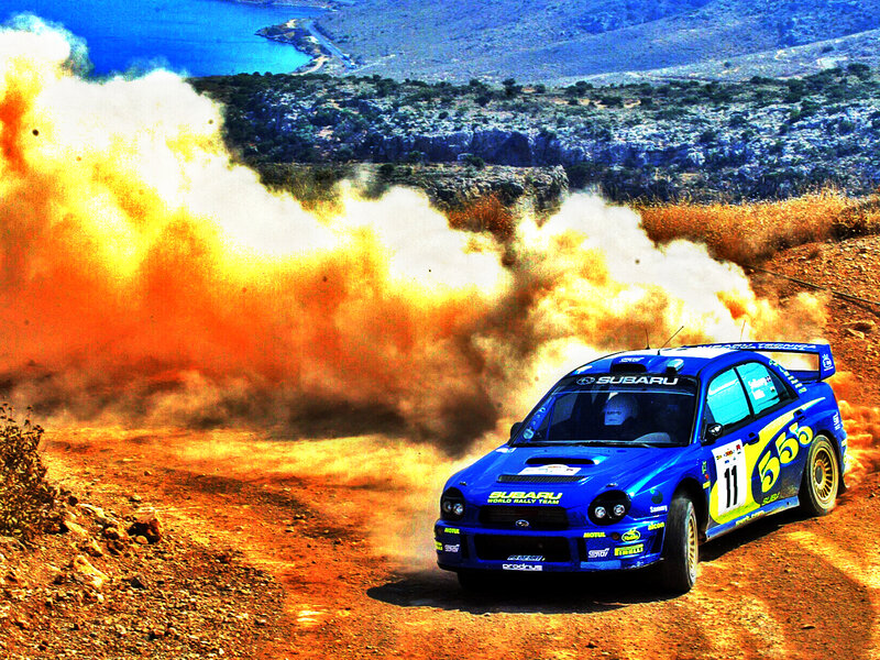 Blue rally car on dirt road
