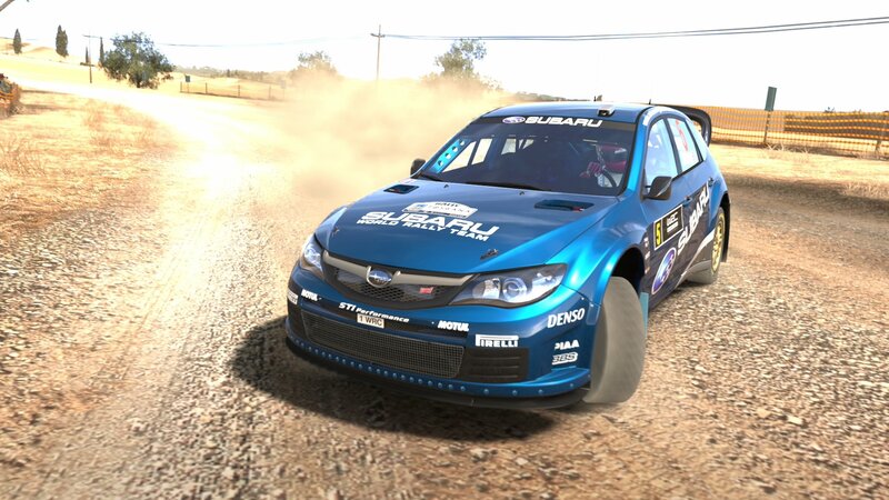 blue rally car on dirt road