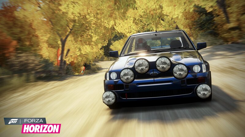 blue rally car on dirt road