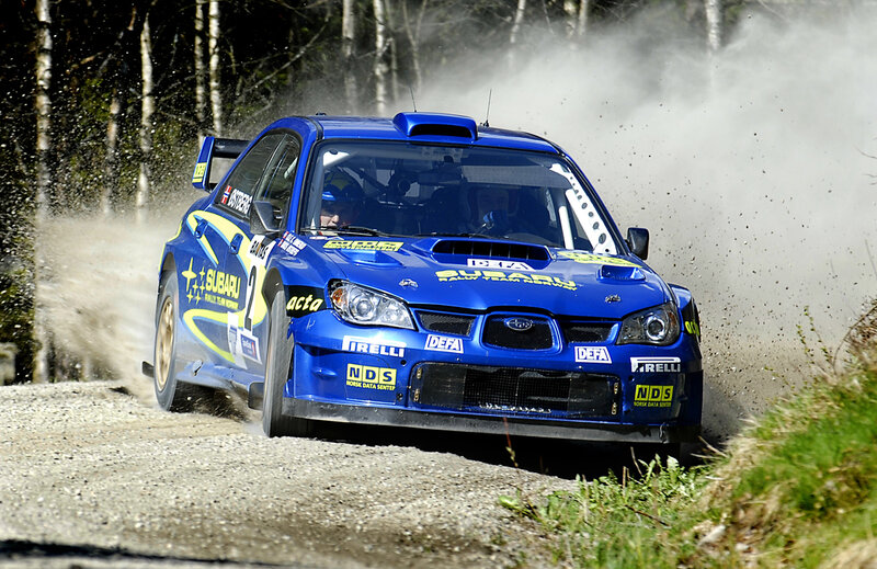 Blue rally car on dirt road