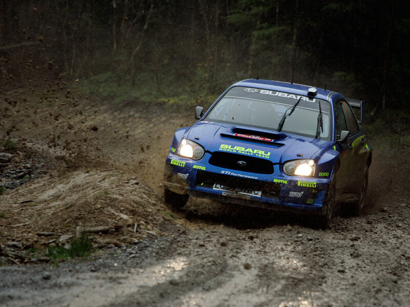 blue rally car on dirt road