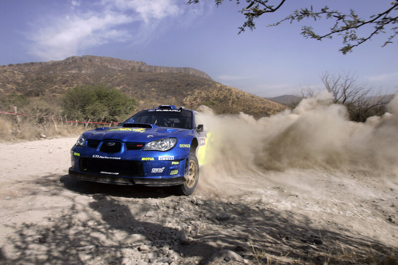 Blue rally car on dirt road