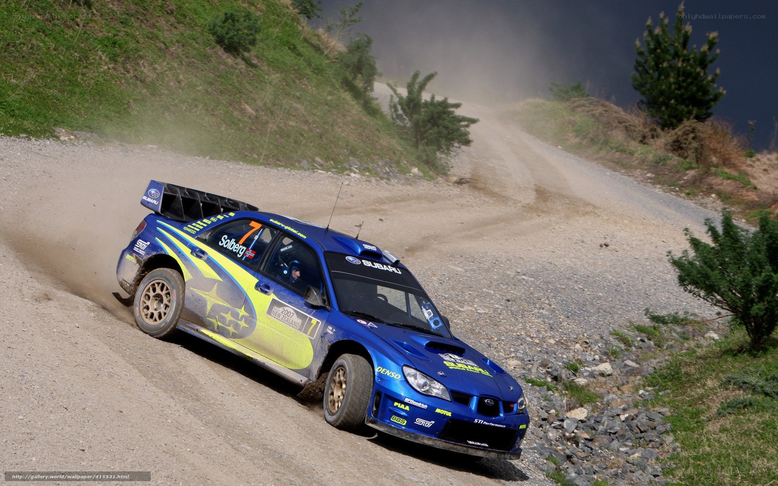 Blue rally car on dirt road