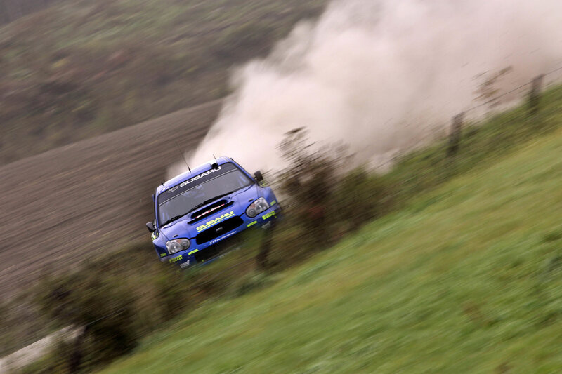 Blue rally car on dirt track