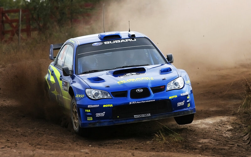 blue rally car on dirt track