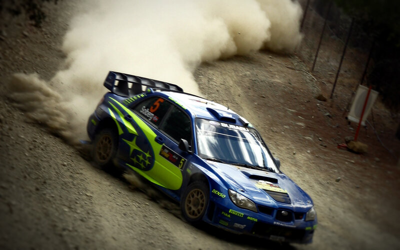 blue rally car on dirt track