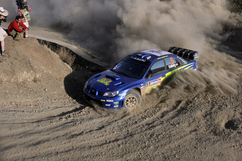 Blue rally car on dirt track