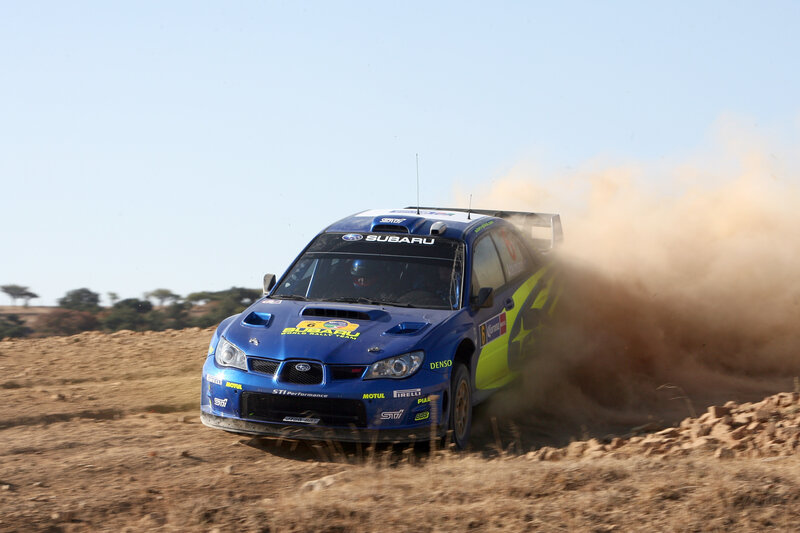 blue rally car on dirt track