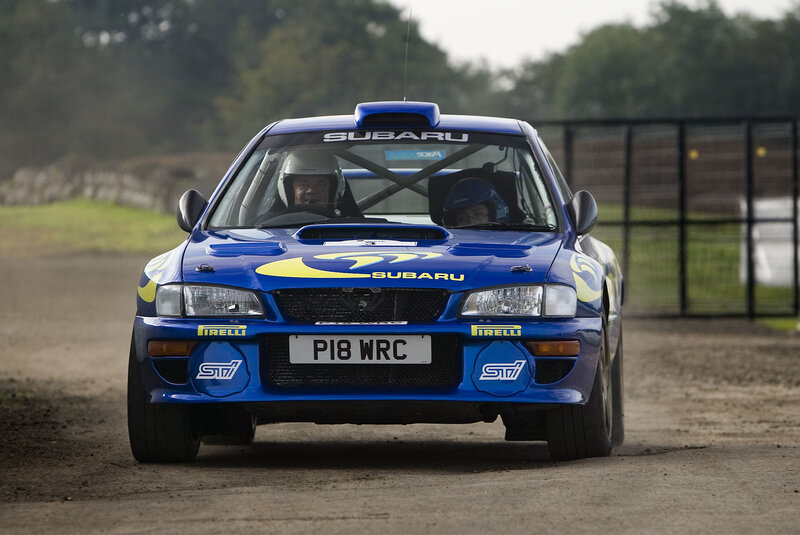 blue rally car on dirt track