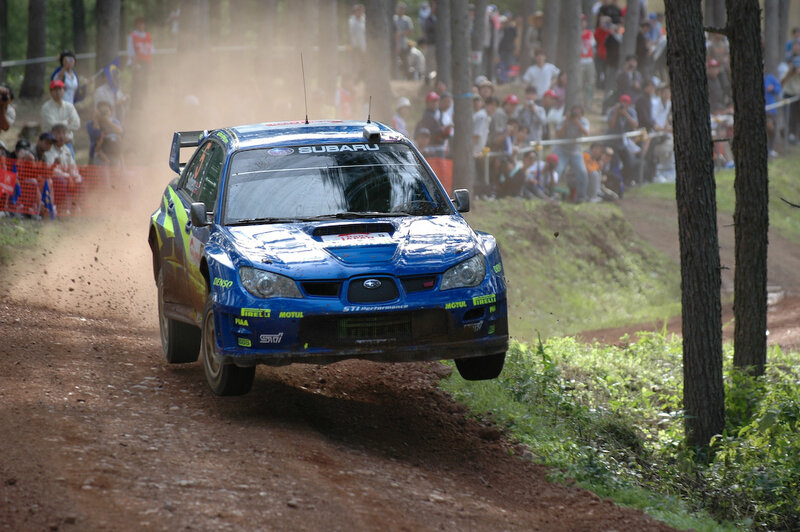 Blue rally car on dirt track