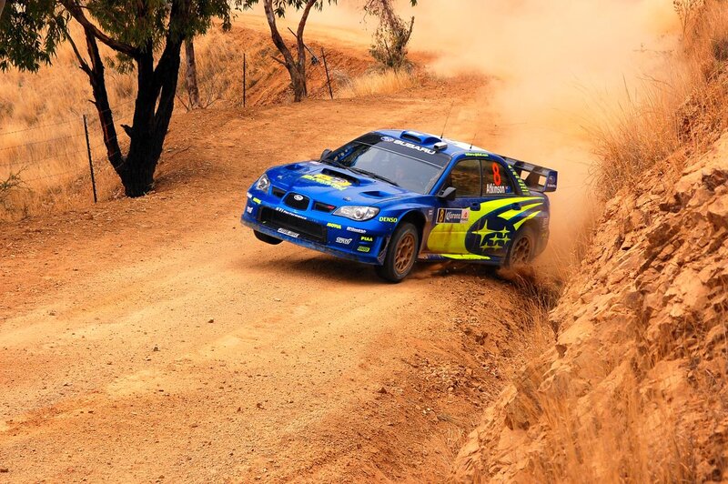 Blue rally car on dirt track