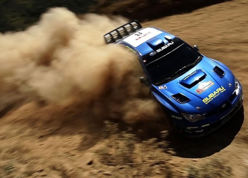 blue rally car on dirt track