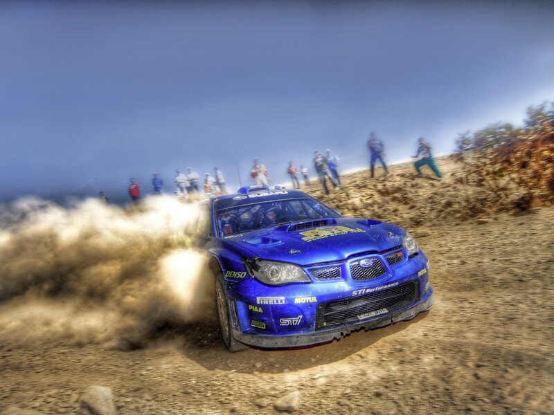 Blue rally car on dirt track