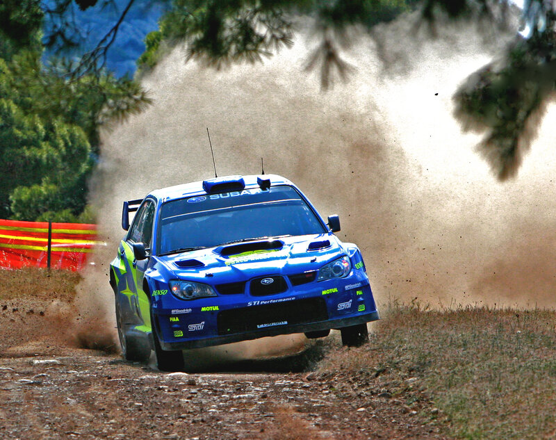 Blue rally car on dirt track