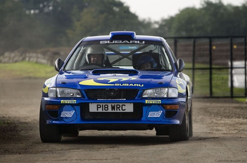 blue rally car on dirt track