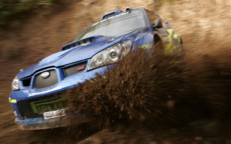 blue rally car on dirt track
