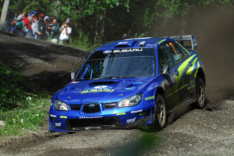 blue rally car on dirt track